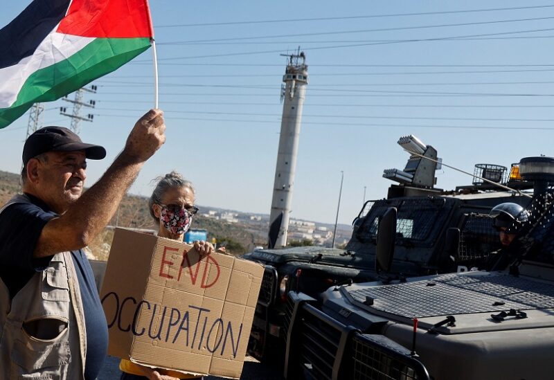 ناشطان من تظاهرات ضد الاستيطان الاسرائيلي في الضفة الغربية (رويترز)