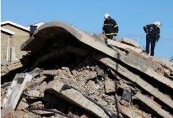 اثنان من عمال الانقاذ في موقع انهيار مبنى في جورج بجنوب أفريقيا - رويترز