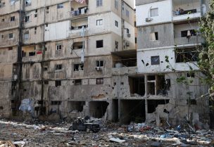 رجال يقفون على شرفة في أحد المواقع المتضررة، بعد دخول وقف إطلاق النار بين إسرائيل وحزب الله حيز التنفيذ. صور، جنوب لبنان 3 ديسمبر/كانون الأول 2024. رويترز