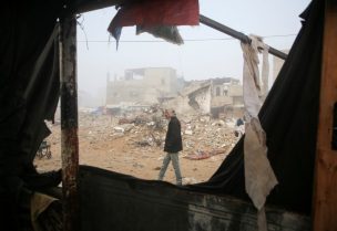 رجل فلسطيني يتفقد الأضرار التي لحقت بخيمة للنازحين بعد غارة جوية إسرائيلية في خان يونس، جنوب قطاع غزة، 17 يناير/كانون الثاني 2025. رويترز