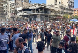 فلسطينيون ينتظرون استلام المساعدات في مدينة غزة، 25 مايو/أيار 2025. رويترز