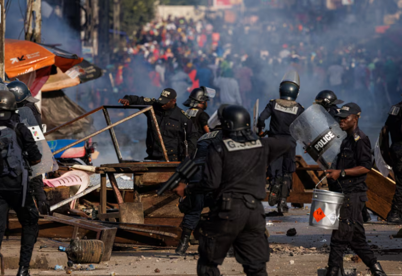 أفراد من قوات الأمن يزيلون حواجز خلال احتجاج يوم الأحد لمؤيدي المرشح الرئاسي الكاميروني عيسى تشيروما الذي أعلن فوزه في الانتخابات الرئاسية-رويترز