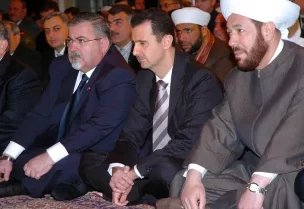 مفتي سوريا السابق أحمد حسون إلى جانب الأسد(أرشيفية- أسوشييتد برس)